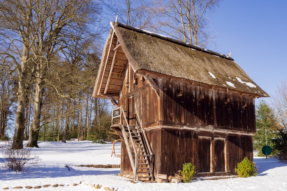 brown wooden house near trees during daytime