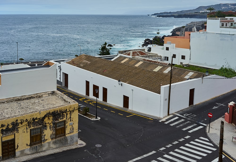 white and brown concrete building near body of water during daytime