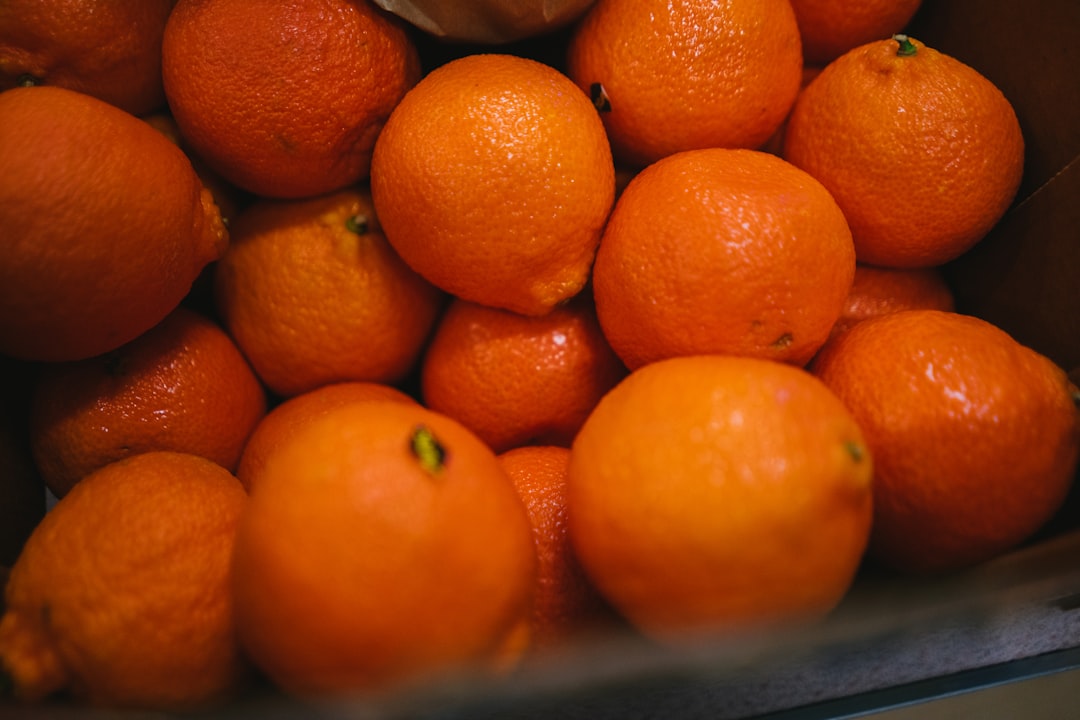 orange fruits on blue plastic container