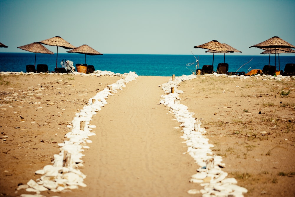 brown beach umbrellas on beach during daytime