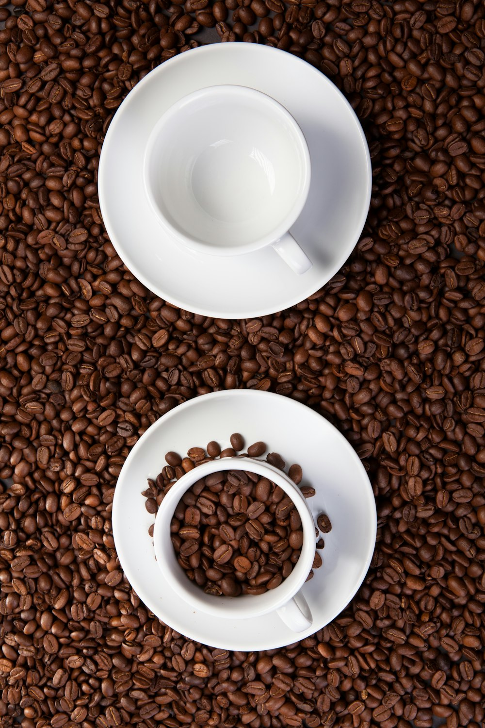 brown coffee beans on white ceramic bowl on white ceramic saucer