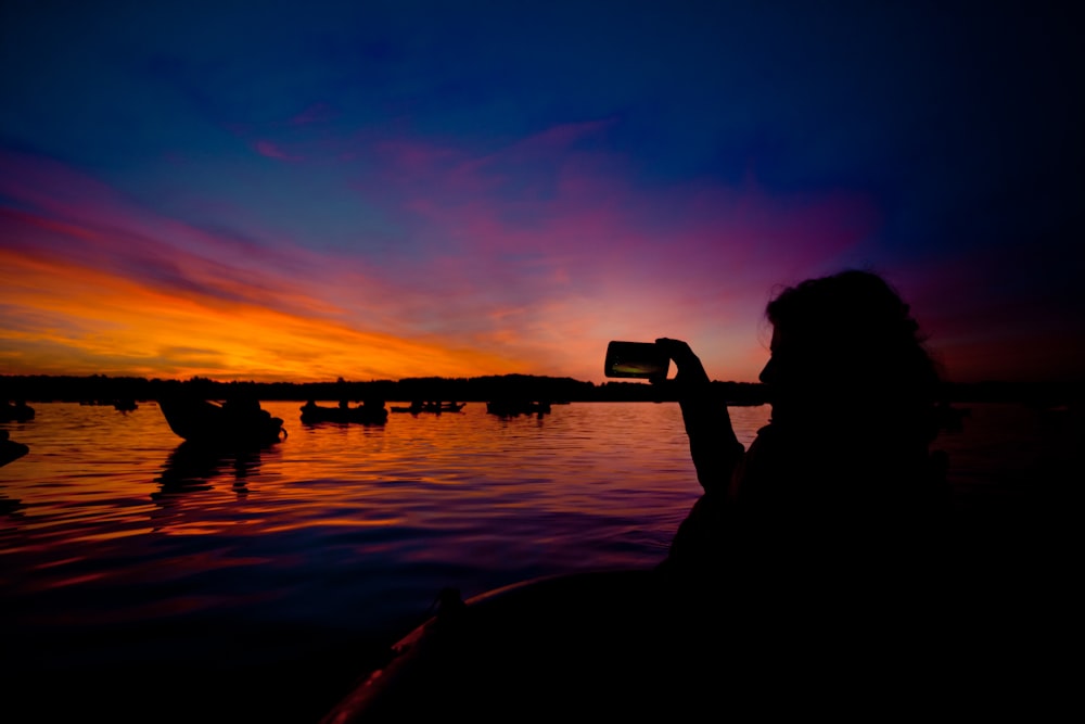 silhouette of man holding smartphone