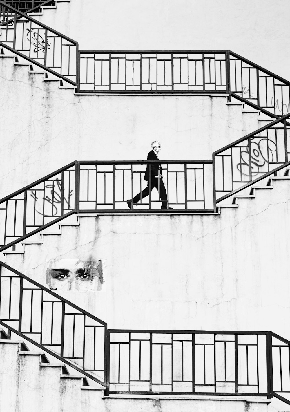 man in black jacket and pants walking down on stairs