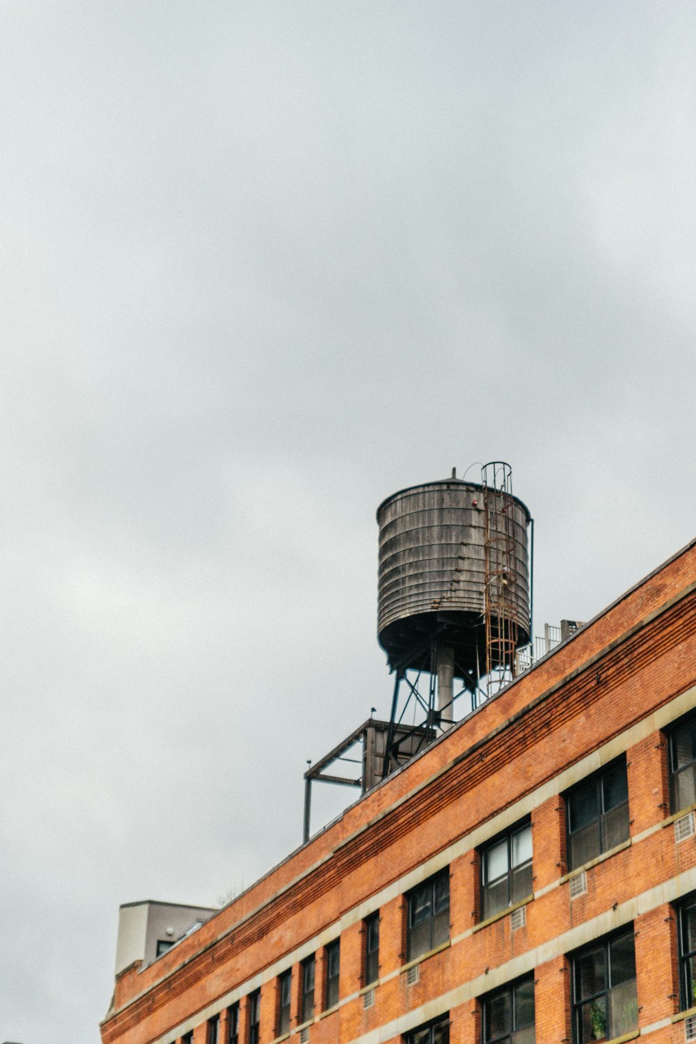 brown and gray concrete building under white clouds during daytime