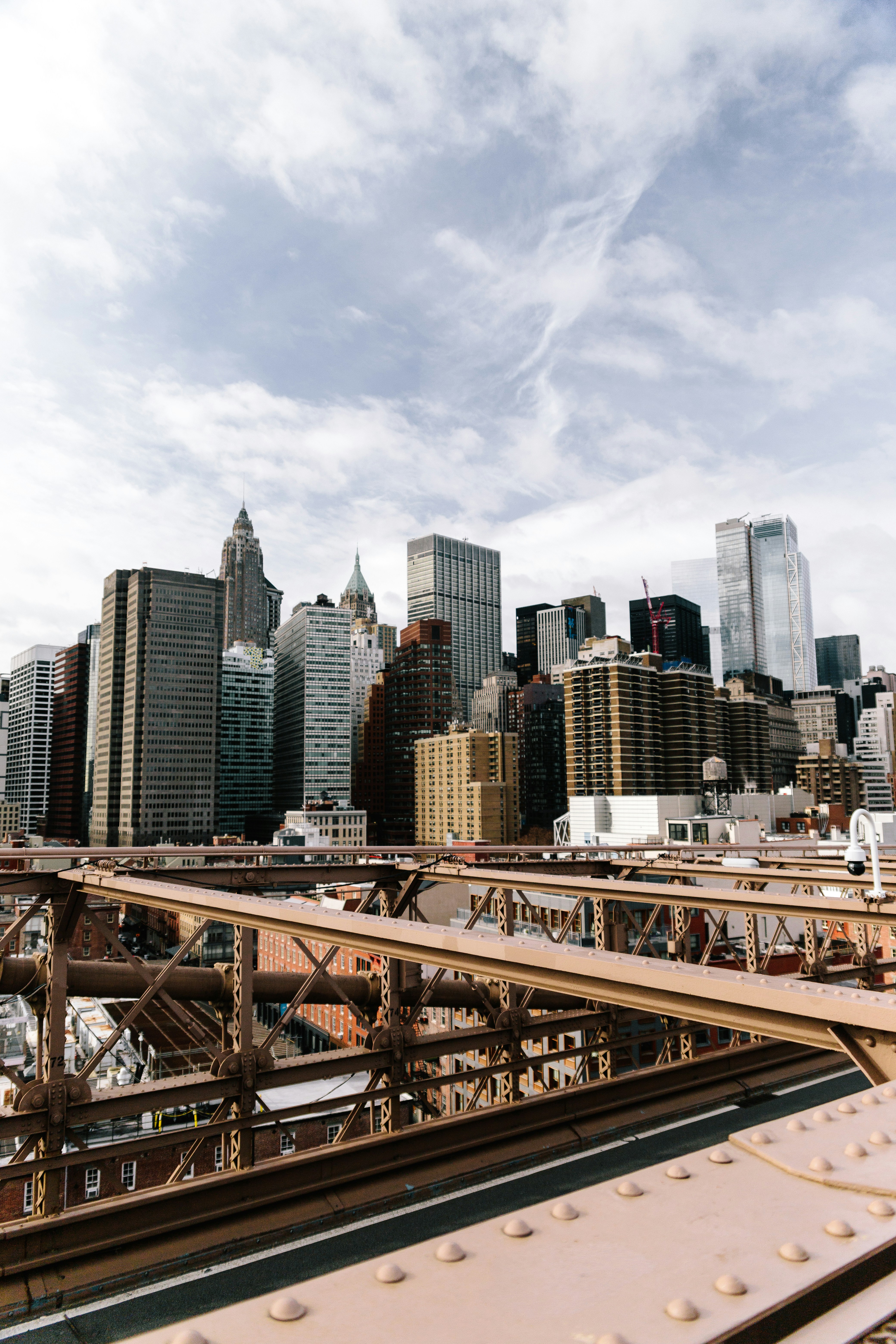 brown metal bridge over city buildings during daytime