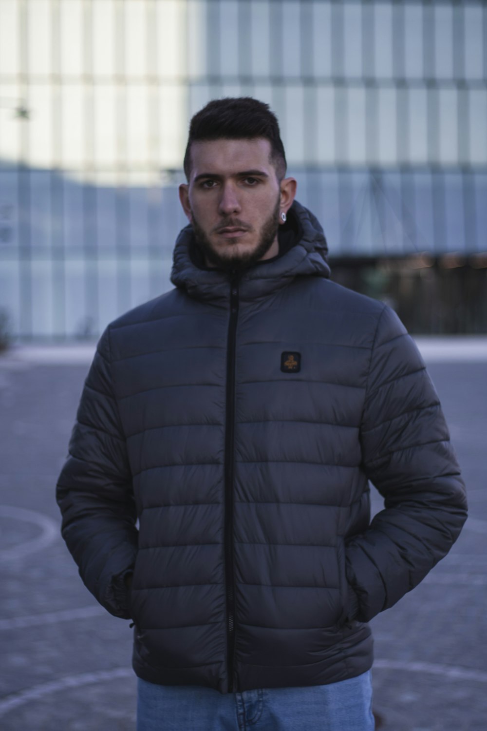 man in black zip up jacket standing on snow covered ground during daytime