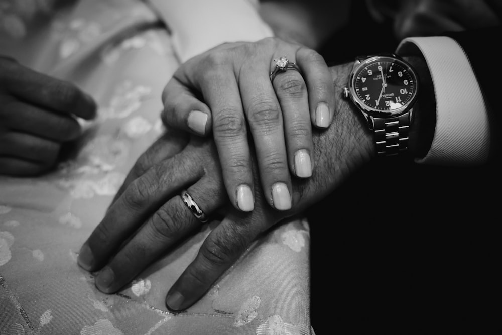 grayscale photo of couple holding hands