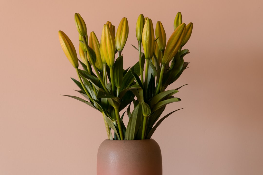yellow flowers on brown ceramic vase