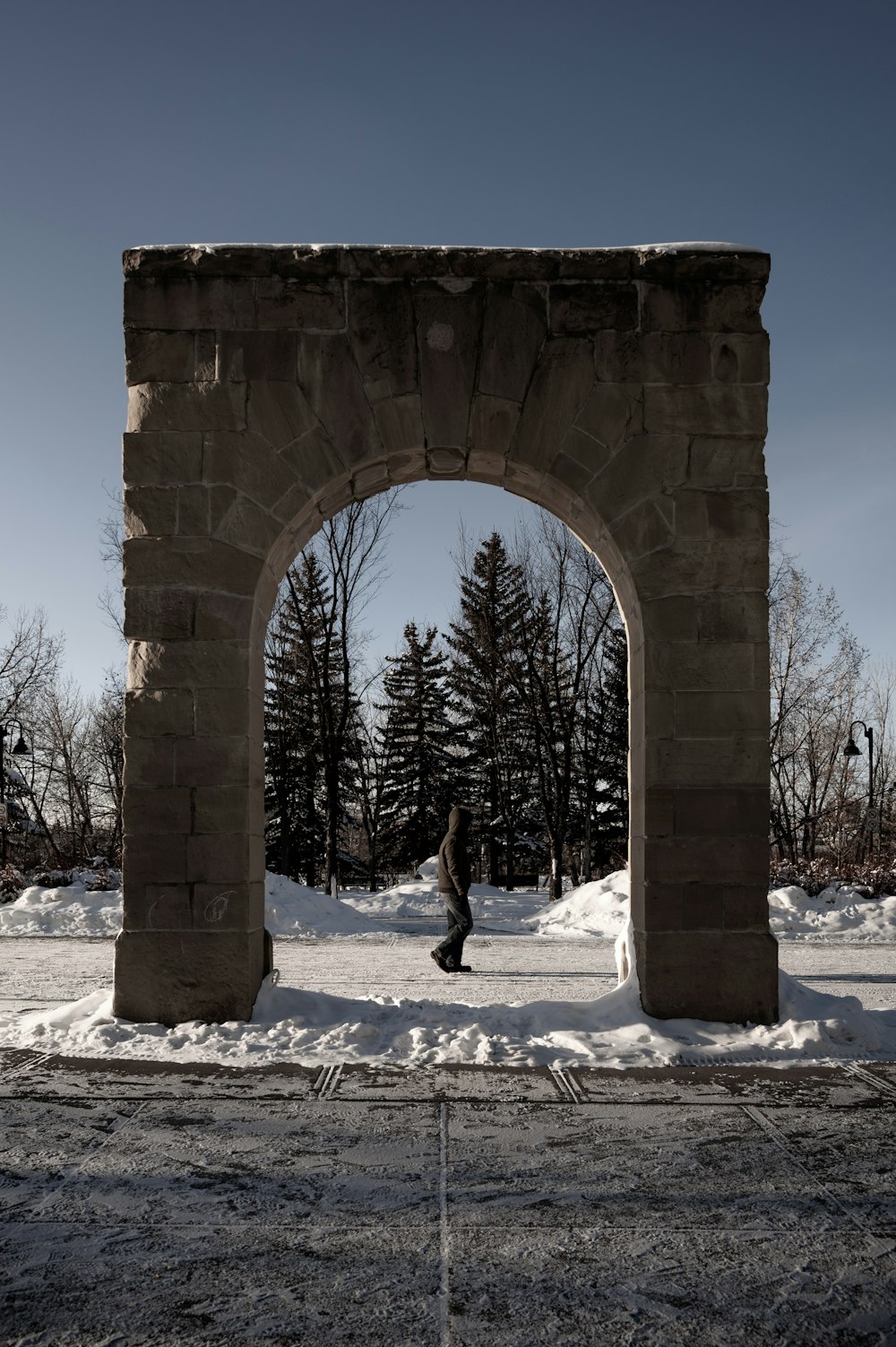 person walking on snow covered ground during daytime