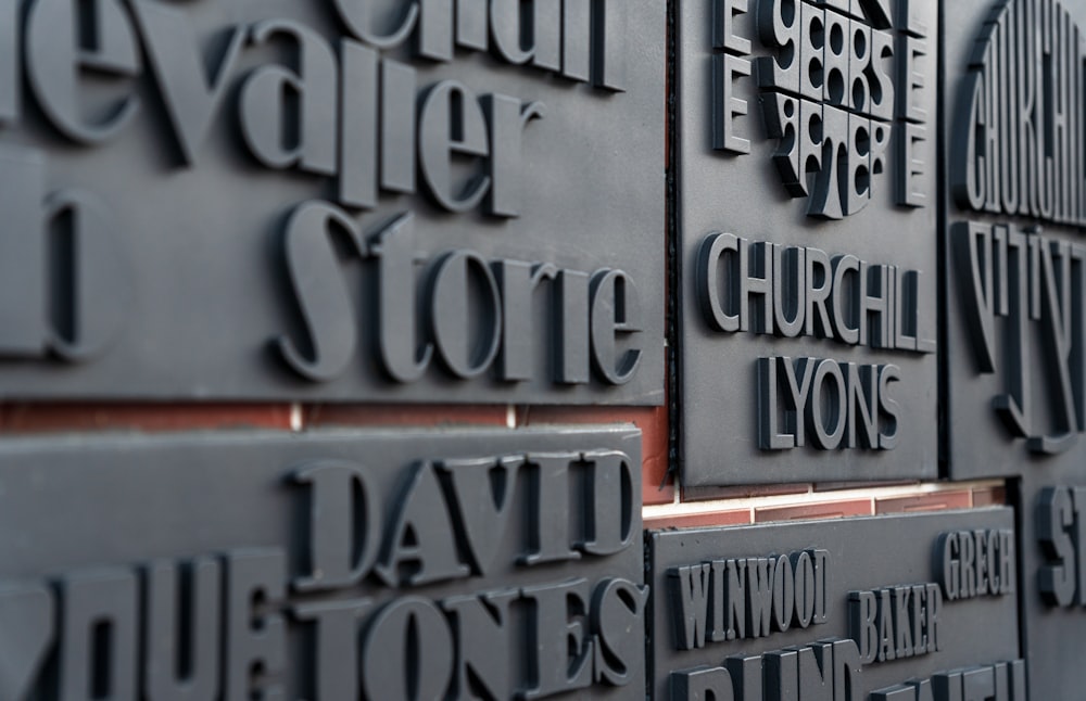 a close up of a wall of names on a building