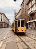 yellow and white tram on street during daytime