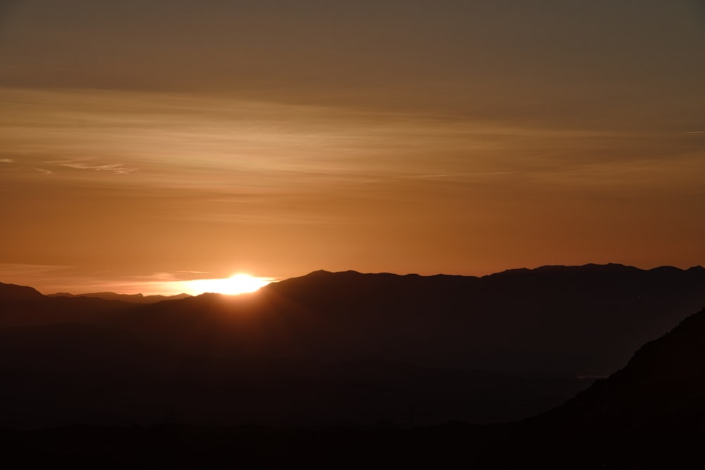 silhouette of mountain during sunset