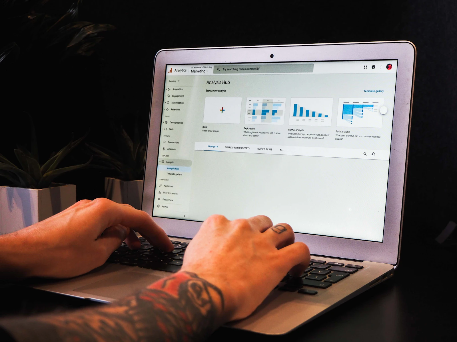 Person using macbook pro on table