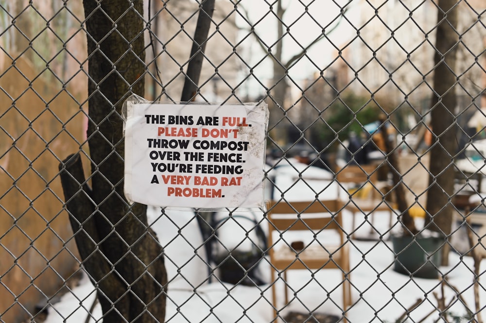 white and black quote on brown wooden fence