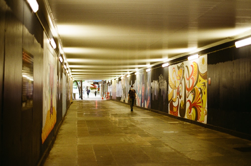 woman in black jacket walking on hallway