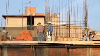 man in blue denim jacket standing beside man in gray shirt