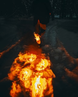 man in black jacket standing on snow covered ground