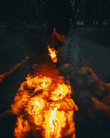 man in black jacket standing on snow covered ground