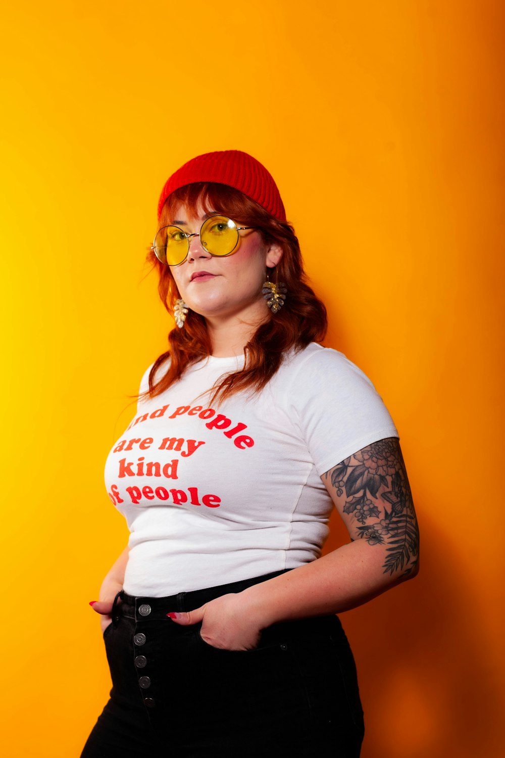 woman in white crew neck t-shirt wearing red knit cap and sunglasses