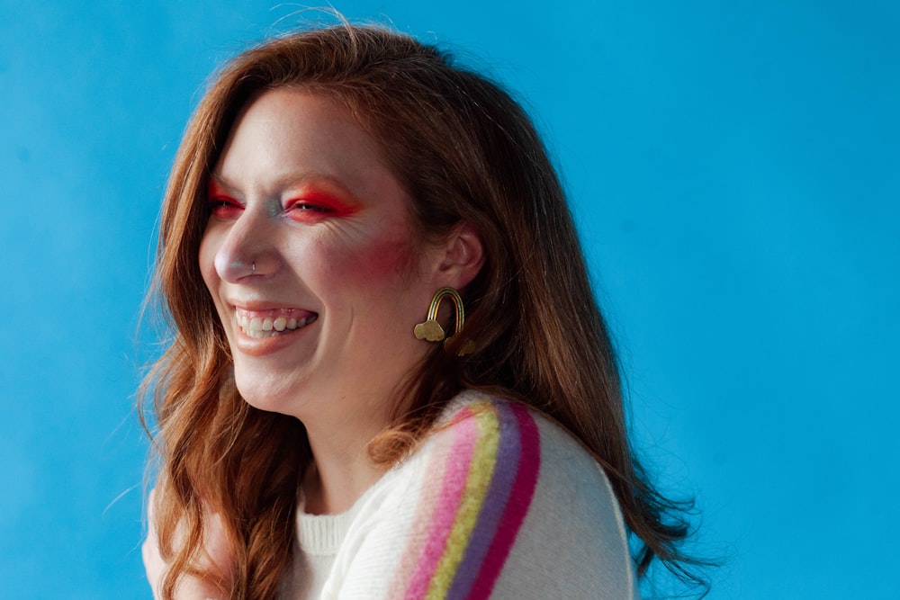 woman in white and pink striped shirt smiling