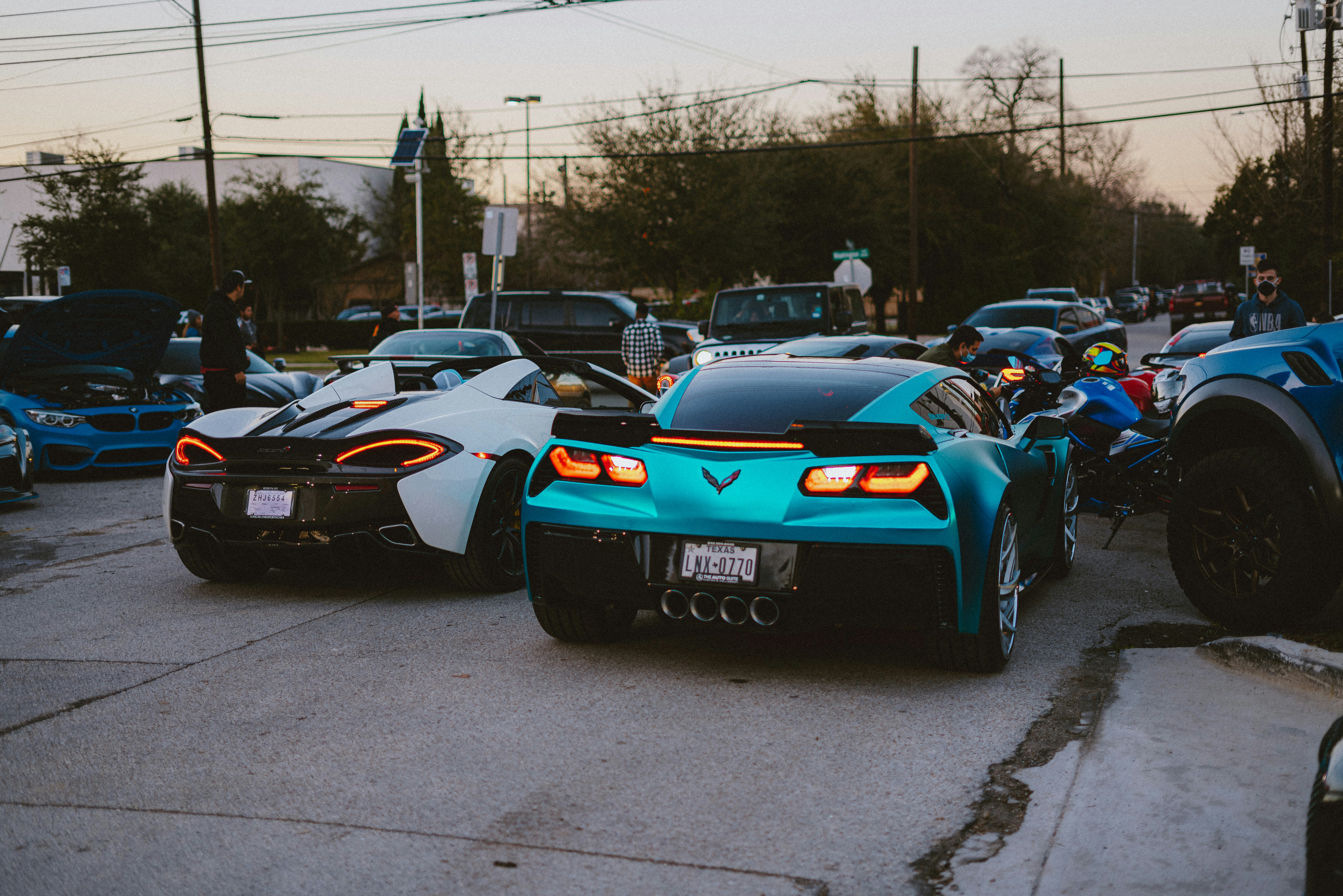 Multiple electric vehicles from different manufacturers charging side by side at a station