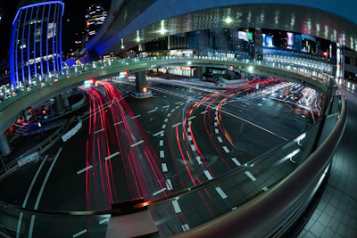 Futuristic digital overlays showing traffic flows on busy urban streets at dusk.