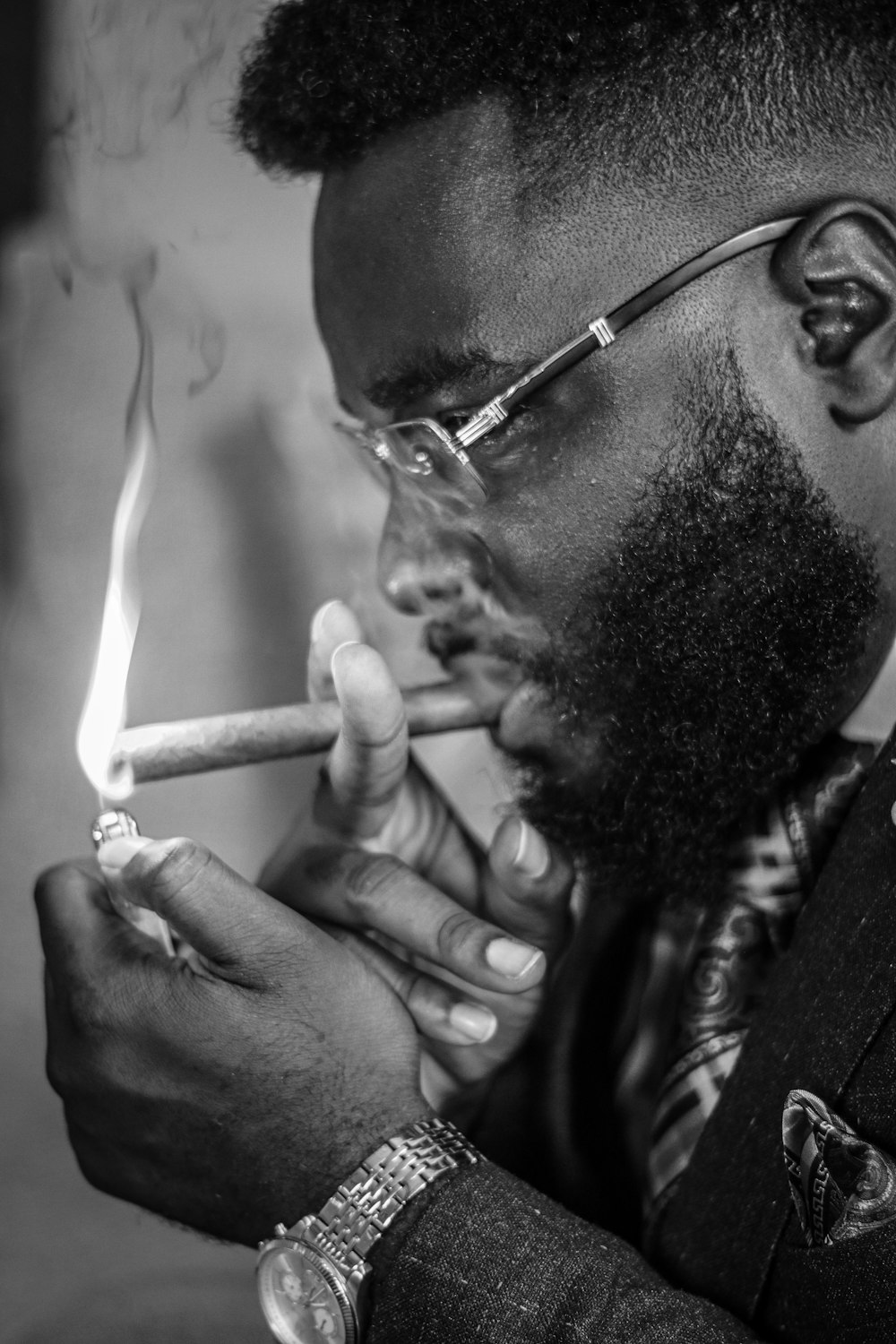 man smoking cigarette in grayscale photography