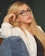 woman in white long sleeve shirt and blue denim jeans wearing black framed eyeglasses