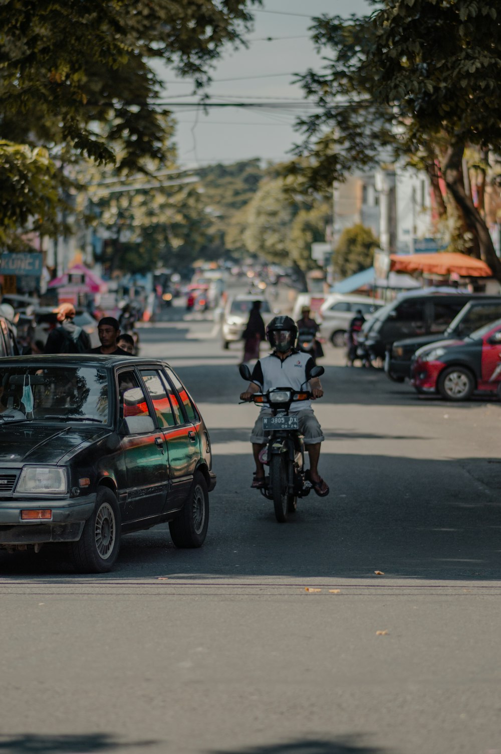 man in black jacket riding motorcycle on road during daytime