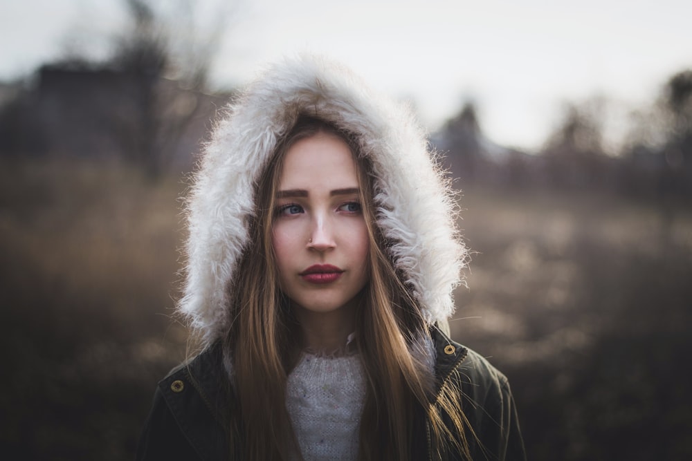 woman in black and white fur lined jacket