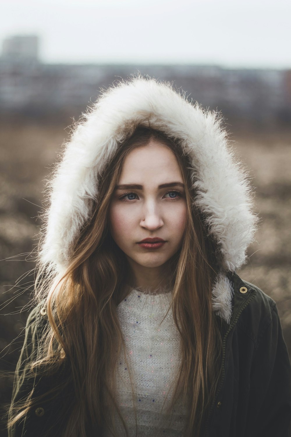 woman in black and white fur lined jacket