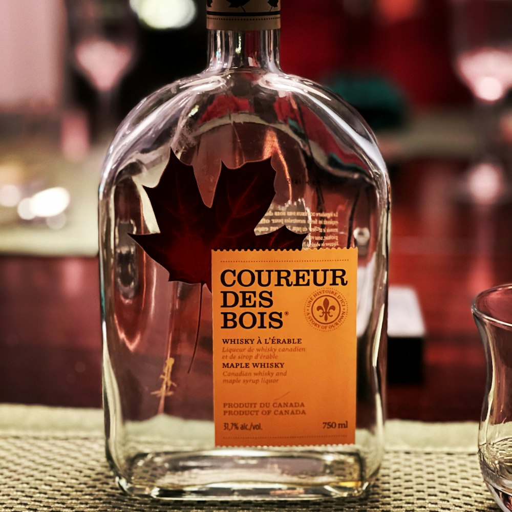 A bottle of courreur des bots on a table photo – Free Canada Image
