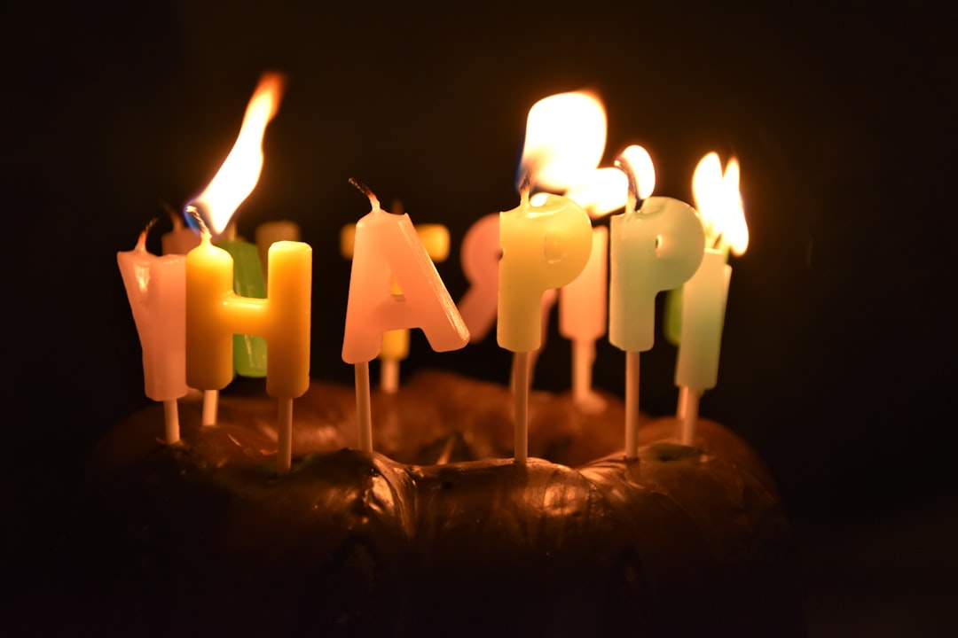 lighted candles on brown cake