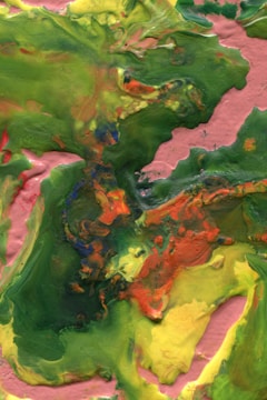 An abstract acrylic painting with swirling greens and yellows on canvas.