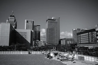 Modern cityscape background with raw construction materials in the foreground.