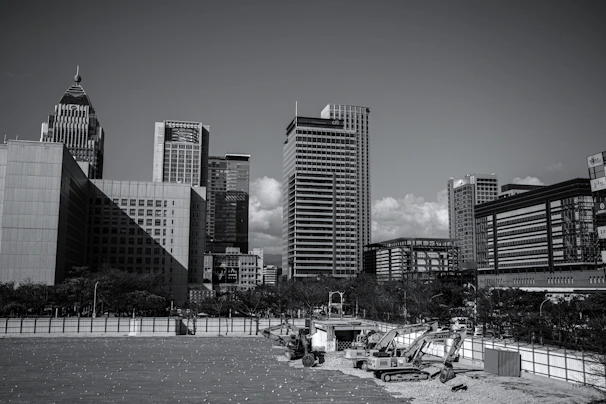 Modern cityscape background with raw construction materials in the foreground.