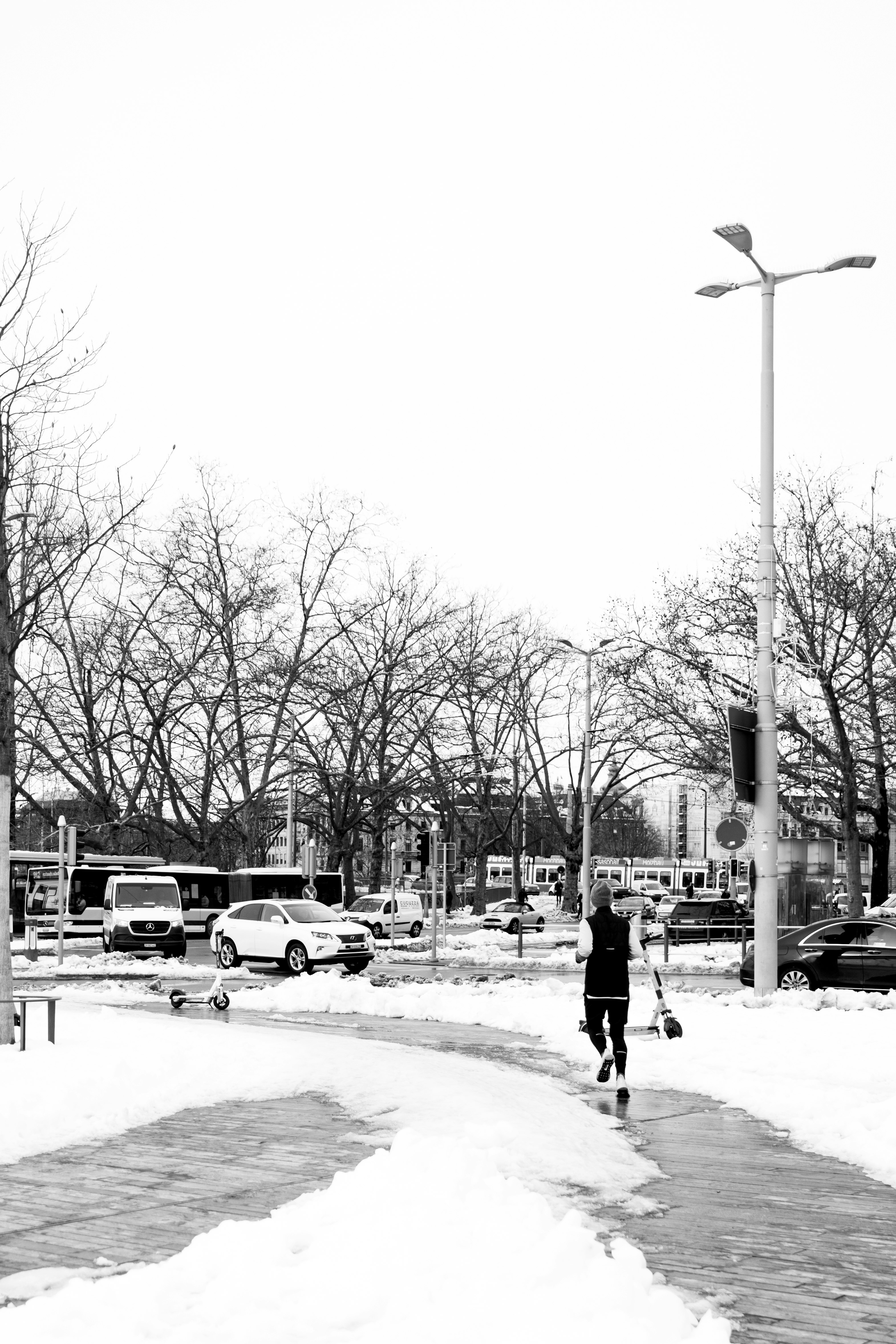 grayscale photo of man walking on street