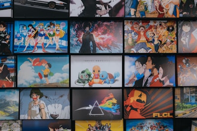 A collection of animated posters arranged in a grid pattern. The images include a mix of famous anime characters, scenes from animated shows, and iconic artwork. Characters from popular series such as Pokémon, Sailor Moon, One Piece, and others are prominently displayed. The overall scene gives off a vibrant and colorful atmosphere.