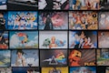 A collection of animated posters arranged in a grid pattern. The images include a mix of famous anime characters, scenes from animated shows, and iconic artwork. Characters from popular series such as Pokémon, Sailor Moon, One Piece, and others are prominently displayed. The overall scene gives off a vibrant and colorful atmosphere.