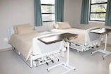 white hospital bed near window