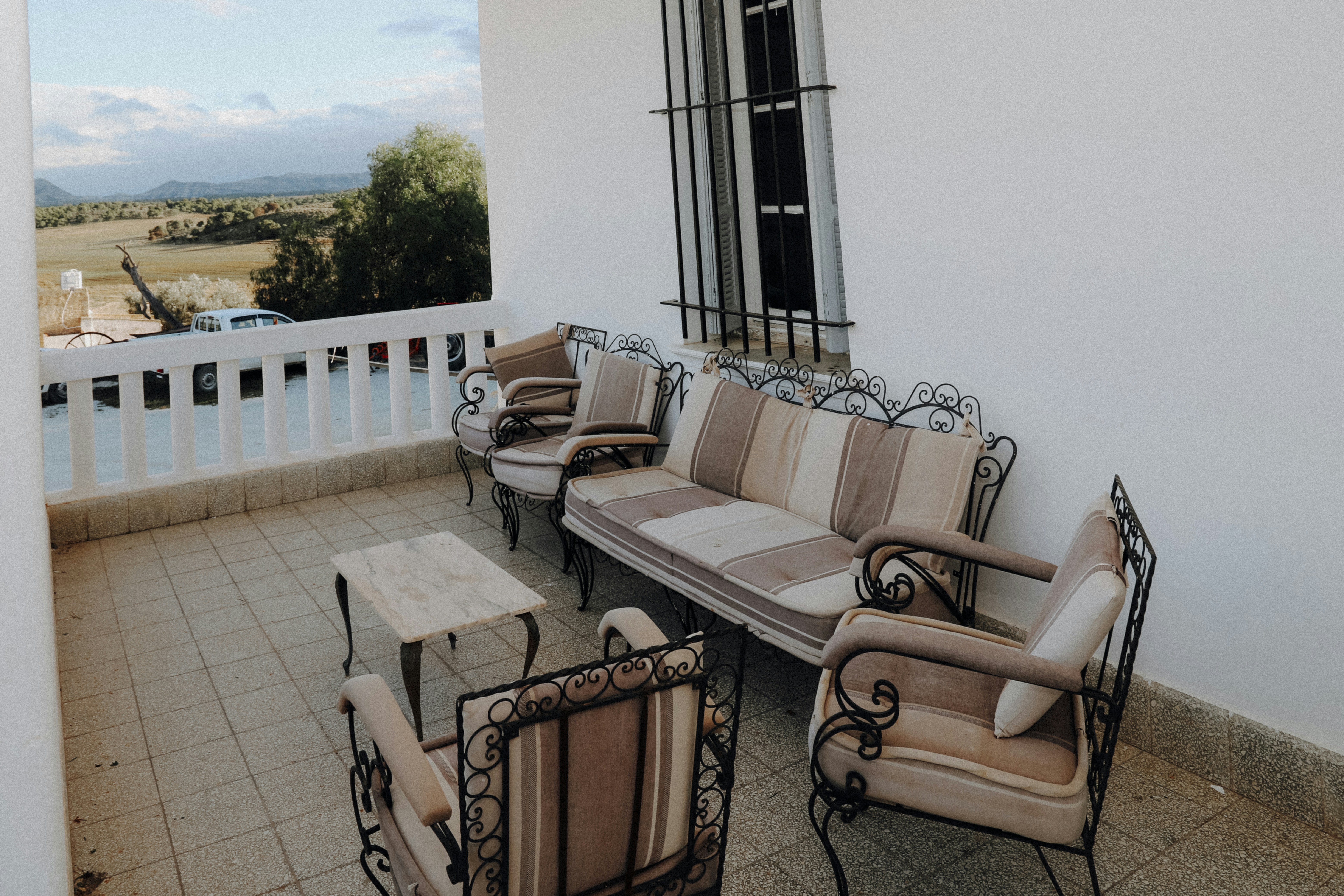 brown wooden framed white padded armchair