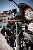 Side view of a black Honda cruiser motorcycle gleaming under bright daylight.