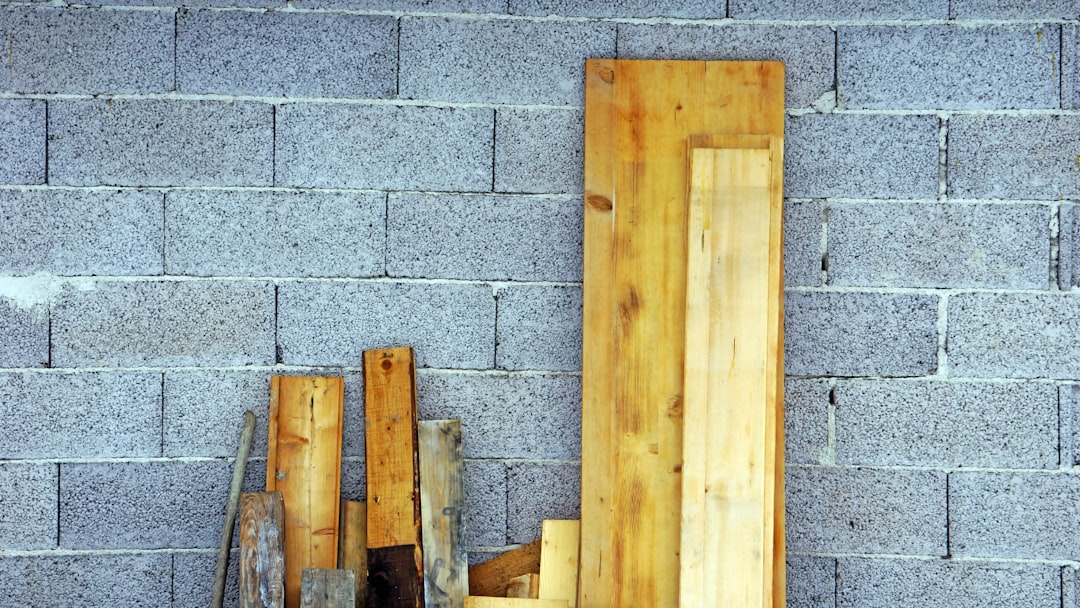 brown wooden board on gray concrete wall