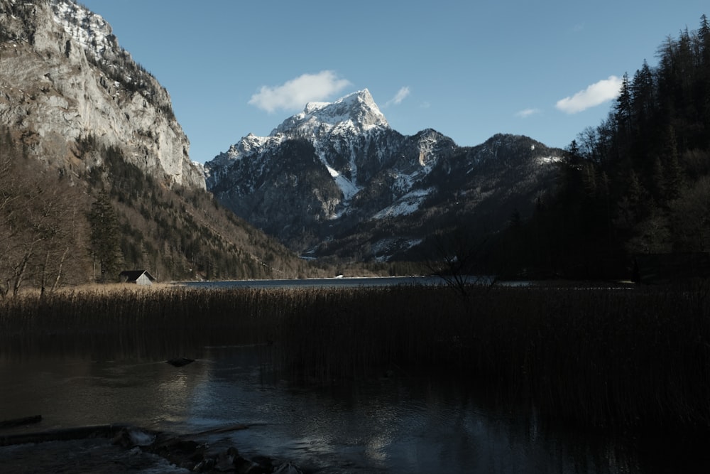 lake near snow covered mountain during daytime