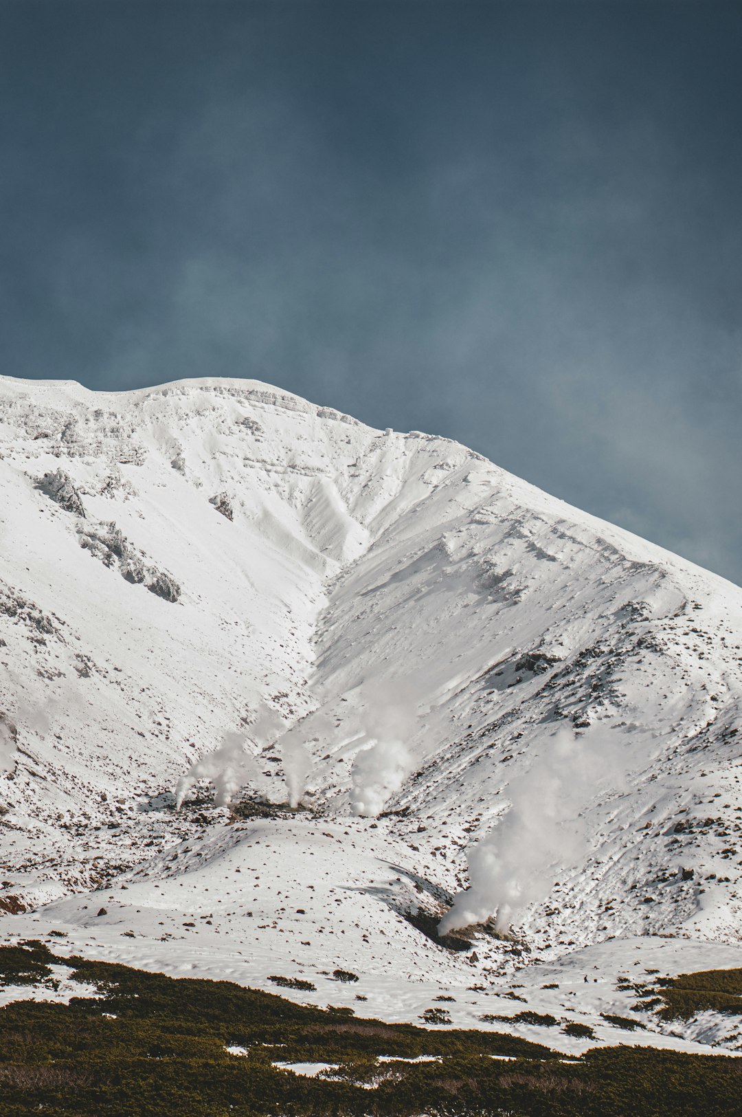 snow covered mountain under blue sky during daytime