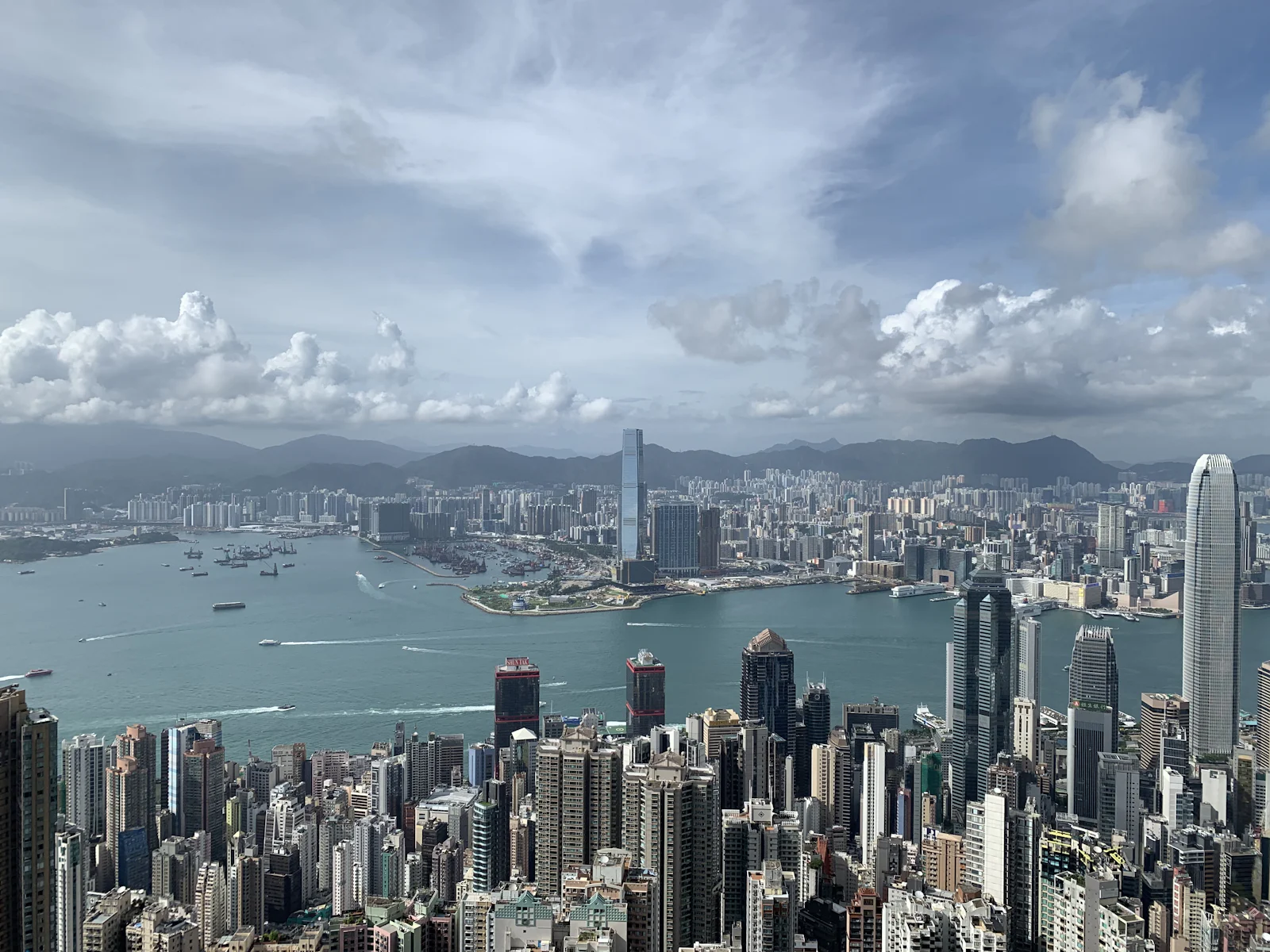 Hong Kong's skyline under a bright blue sky, viewed from Victoria Peak