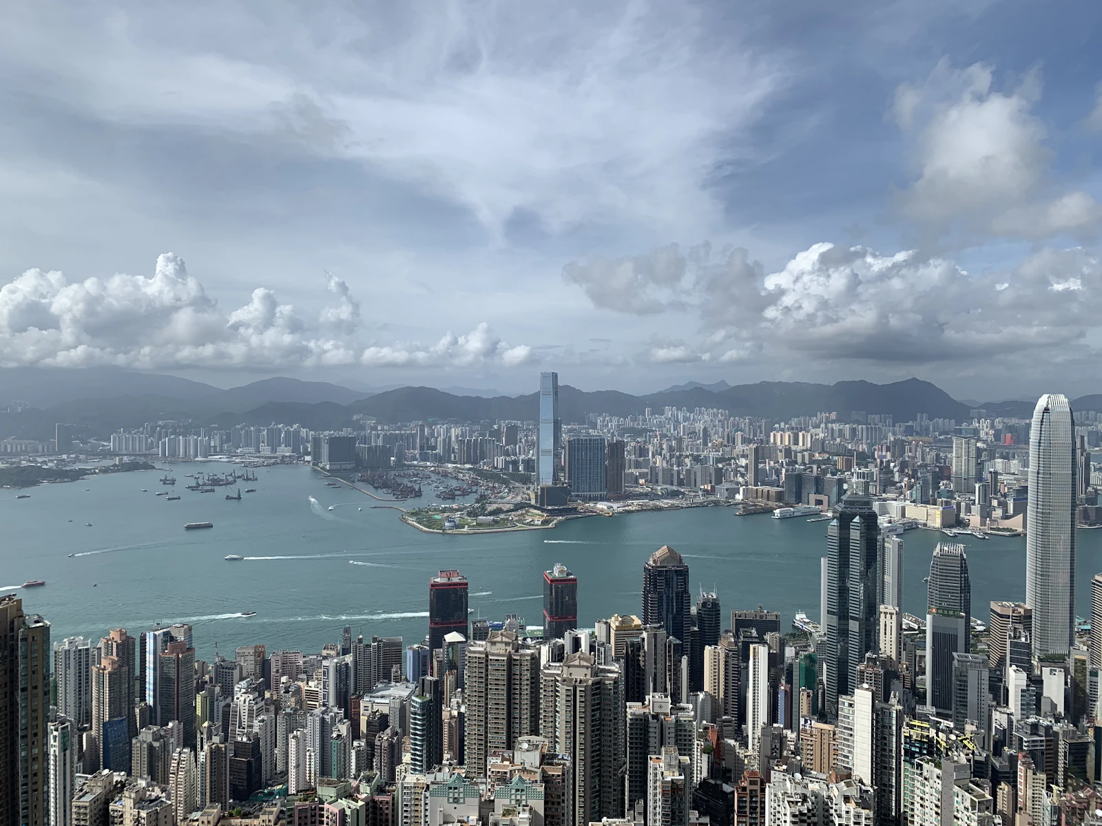 Hong Kong's skyline under a bright blue sky, viewed from Victoria Peak