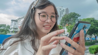 A happy young Colombian woman using a mobile banking app to check her savings balance.