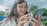 A happy woman using her smartphone in a safe and bright urban environment.