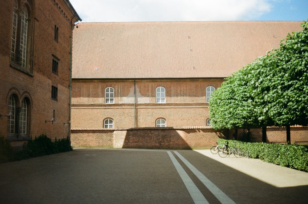 brown concrete building near green trees during daytime